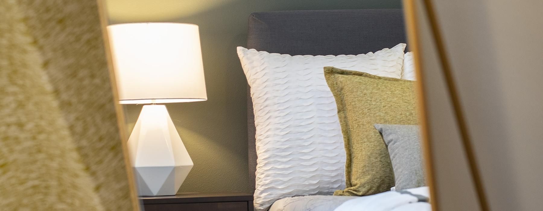 a bed with a lamp on the side