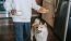 a dog and a person holding a plate of food