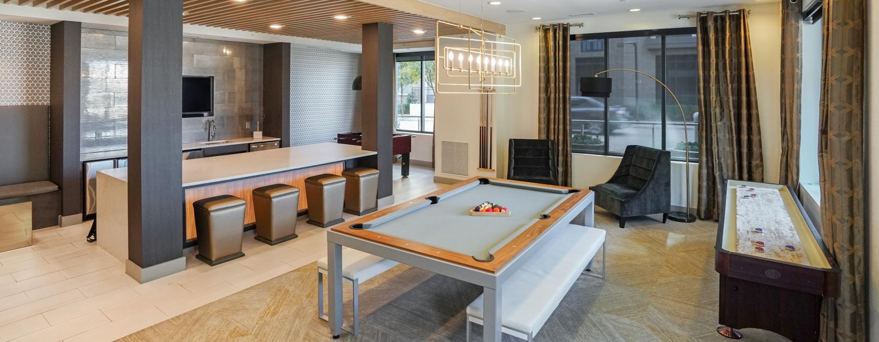 a large room with a pool table and chairs