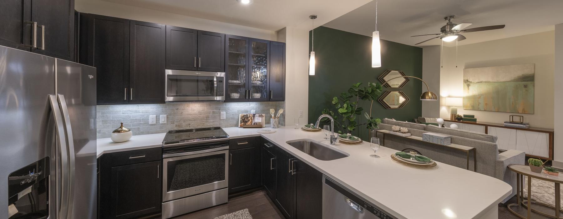 a kitchen with black cabinets