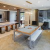 a large room with a pool table and chairs	