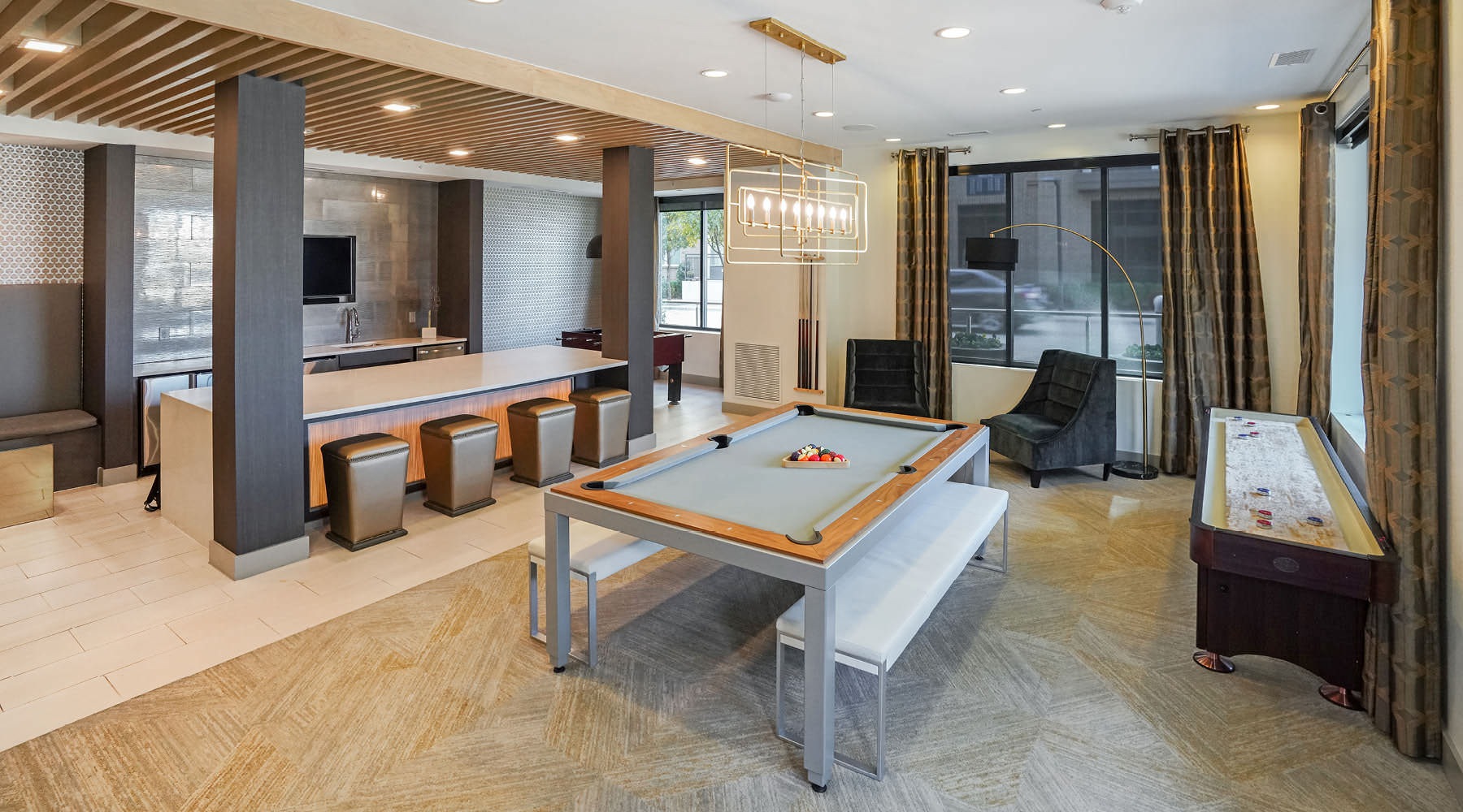 Find your perfect fit at The Lyla a large room with a pool table and chairs