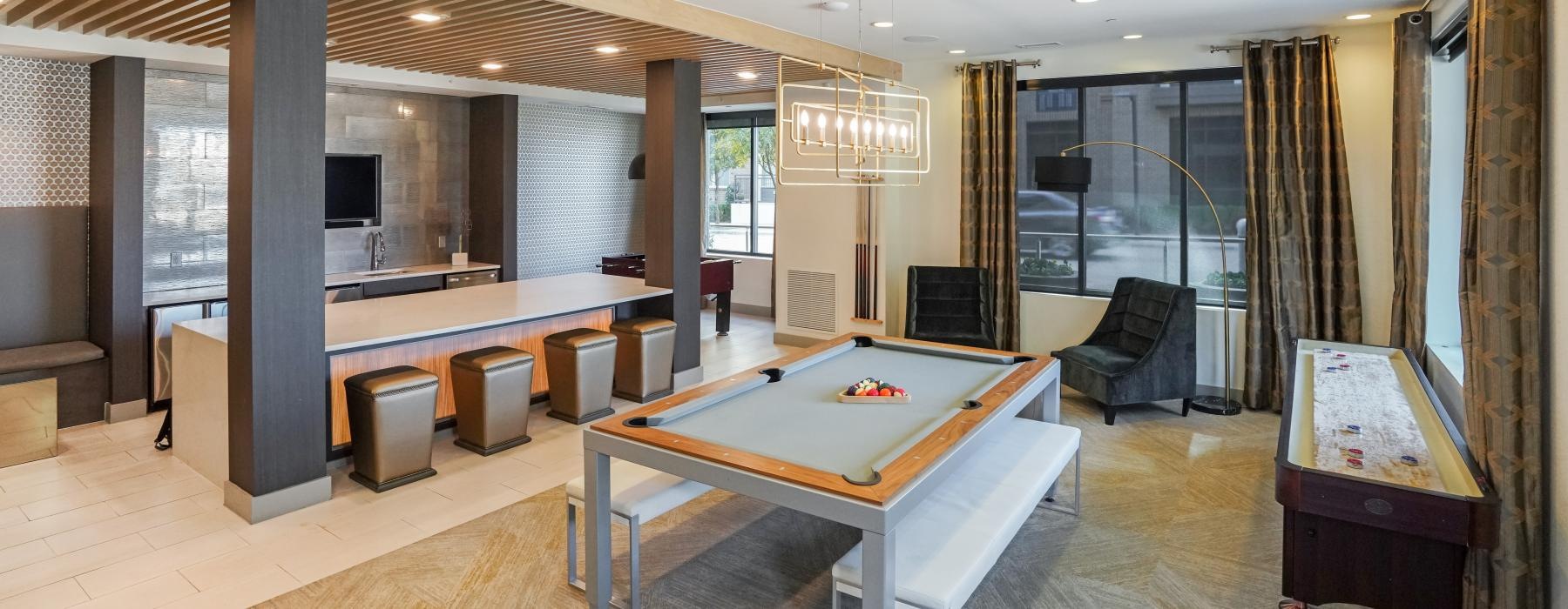 a large room with a pool table and chairs