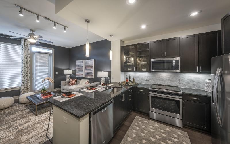 a kitchen with black cabinets